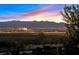 Enjoy breathtaking skyline views from this property, showcasing the city lights against a mountain backdrop at twilight at 1221 Diamond Valley St, Henderson, NV 89052