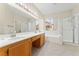 Spacious bathroom with double sinks, a soaking tub, and a glass-enclosed shower at 1287 Dove Tree Ct, Henderson, NV 89014