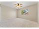 Bright, carpeted bedroom with a ceiling fan and a view of the outdoors through a window at 1287 Dove Tree Ct, Henderson, NV 89014