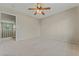Spacious bedroom with a ceiling fan and access to a landing, offering a blend of comfort and openness at 1287 Dove Tree Ct, Henderson, NV 89014