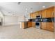 Open kitchen with stainless steel appliances, granite countertops, and seamless flow to living area at 1287 Dove Tree Ct, Henderson, NV 89014