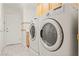 Well-lit laundry room featuring a modern washer and dryer set for efficient cleaning at 1287 Dove Tree Ct, Henderson, NV 89014