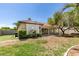 Spacious backyard with lawn, landscaping, and a view of the home's exterior and covered patio at 1454 Erskine Ave, Las Vegas, NV 89123