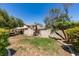 Large backyard with mature landscaping, partial grass coverage, and view of the home's exterior at 1454 Erskine Ave, Las Vegas, NV 89123