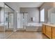 Primary bathroom showcases a glass enclosed shower, soaking tub, and vanity at 1454 Erskine Ave, Las Vegas, NV 89123