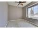 Unfurnished bedroom featuring a ceiling fan and large window for natural light at 1454 Erskine Ave, Las Vegas, NV 89123