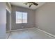 Empty bedroom with a ceiling fan, large window, and potential for customization at 1454 Erskine Ave, Las Vegas, NV 89123