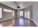 Bedroom featuring wood floors, a ceiling fan, and access to a patio through French doors at 1454 Erskine Ave, Las Vegas, NV 89123