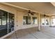 Covered patio with ceiling fans, concrete floors, and access to the backyard and house at 1454 Erskine Ave, Las Vegas, NV 89123