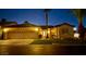 Inviting single-story home with a three-car garage and manicured front lawn at twilight at 1454 Erskine Ave, Las Vegas, NV 89123