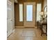 Inviting foyer with tiled floor, decorative door with sidelights, console table and mirror at 1454 Erskine Ave, Las Vegas, NV 89123