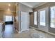 Bright foyer with tile flooring, decorative front door, and access to other rooms at 1454 Erskine Ave, Las Vegas, NV 89123