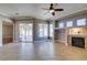 Cozy living room with fireplace and large windows that lead to a screened in patio at 1454 Erskine Ave, Las Vegas, NV 89123