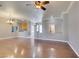 Open-concept living room with hardwood floors, neutral paint, ceiling fan, and chandelier at 1454 Erskine Ave, Las Vegas, NV 89123
