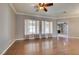 Spacious living room with hardwood floors, natural light, and ceiling fan at 1454 Erskine Ave, Las Vegas, NV 89123