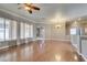 Large living room with wood flooring, modern chandelier, ceiling fan, and open layout at 1454 Erskine Ave, Las Vegas, NV 89123