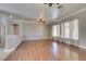 Open living room showcases hardwood flooring, a ceiling fan, and multiple windows at 1454 Erskine Ave, Las Vegas, NV 89123