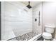 Updated bathroom showcasing modern black fixtures, marble tile, and a walk-in shower at 1574 Teardrop St, Las Vegas, NV 89142