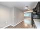 Dining room showcasing wood floors and gray paint, seamlessly flowing into an adjoining room at 1574 Teardrop St, Las Vegas, NV 89142