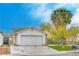 Charming single-story home featuring a two-car garage, well-maintained lawn and mature landscaping at 1574 Teardrop St, Las Vegas, NV 89142