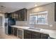 Modern kitchen featuring sleek black cabinets, subway tile backsplash, and stainless steel appliances at 1574 Teardrop St, Las Vegas, NV 89142