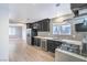 Modern kitchen featuring stainless appliances, wine fridge, updated lighting and subway tile at 1574 Teardrop St, Las Vegas, NV 89142