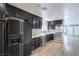 Modern kitchen featuring stainless appliances, wine fridge, updated lighting and subway tile at 1574 Teardrop St, Las Vegas, NV 89142