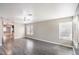 Bright living room with neutral paint, updated ceiling fan and modern gray floors at 1574 Teardrop St, Las Vegas, NV 89142