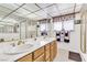 Bright bathroom with a double sink vanity, shower, and soaking tub with gold fixtures at 1751 E Reno Ave # 206, Las Vegas, NV 89119