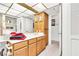 Bright bathroom with double sinks, wood cabinets, and a separate water closet at 1751 E Reno Ave # 206, Las Vegas, NV 89119