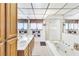 Bright bathroom with a double sink vanity, shower, and soaking tub with gold fixtures at 1751 E Reno Ave # 206, Las Vegas, NV 89119