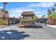 Gated community entrance with desert landscaping, palm trees, and secure access at 1751 E Reno Ave # 206, Las Vegas, NV 89119