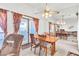 Open dining room with ceiling fan, mirror wall, and access to outdoor balcony at 1751 E Reno Ave # 206, Las Vegas, NV 89119