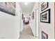 Hallway decorated with framed art that leads to the living room area at 1751 E Reno Ave # 206, Las Vegas, NV 89119