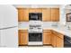 Bright kitchen featuring modern appliances, ample cabinet space, and tile countertops at 1751 E Reno Ave # 206, Las Vegas, NV 89119