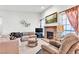 Comfortable living room with a brick fireplace, large windows, and plush seating arrangements at 1751 E Reno Ave # 206, Las Vegas, NV 89119