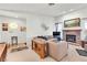 A spacious living room featuring a cozy fireplace, comfortable seating, and natural light at 1751 E Reno Ave # 206, Las Vegas, NV 89119