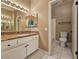 Bathroom boasts a granite vanity, decorative lighting, and tiled floors at 1851 Hillpointe Rd # 2124, Henderson, NV 89074
