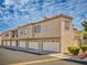 Two-story condo building features attached garages and desert landscaping at 1851 Hillpointe Rd # 2124, Henderson, NV 89074