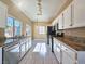 Bright kitchen features stainless steel appliances, granite countertops, and ample cabinet space at 1851 Hillpointe Rd # 2124, Henderson, NV 89074