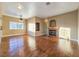 Bright living room boasts hardwood floors, a ceiling fan, and a fireplace with tile surround at 1851 Hillpointe Rd # 2124, Henderson, NV 89074