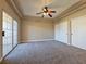 Carpeted main bedroom features a tray ceiling, fan, and large closet at 1851 Hillpointe Rd # 2124, Henderson, NV 89074
