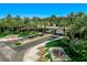 Aerial view of gated entrance with lush landscaping, palm trees, and fountains at 2325 Prometheus Ct, Henderson, NV 89074