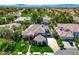 Impressive aerial view of a home with manicured lawns, mature trees, and an expansive driveway at 2325 Prometheus Ct, Henderson, NV 89074