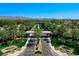 Aerial view of a gated entrance leading into a neighborhood with palm trees and lush landscaping at 2325 Prometheus Ct, Henderson, NV 89074