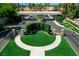 Aerial view of gated entrance with manicured greenery, palm trees, and landscaped median at 2325 Prometheus Ct, Henderson, NV 89074