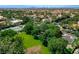 Expansive aerial view showcasing the estate's tennis courts, lush green spaces, and mature landscaping at 2325 Prometheus Ct, Henderson, NV 89074