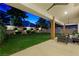 Inviting backyard featuring a manicured lawn, trees, covered patio, and stylish outdoor seating for relaxation at 2325 Prometheus Ct, Henderson, NV 89074