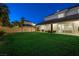 Spacious backyard boasts lush lawn and a covered patio, perfect for entertaining guests or Gathering fun at 2325 Prometheus Ct, Henderson, NV 89074