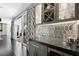 Elegant bar area featuring sleek countertops, stylish cabinets with wine storage, and a mirrored backsplash with modern finishes at 2325 Prometheus Ct, Henderson, NV 89074
